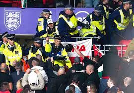 As visiting fans clash with Wembley police, England and Hungary play to a 1-1 World Cup qualifying draw.